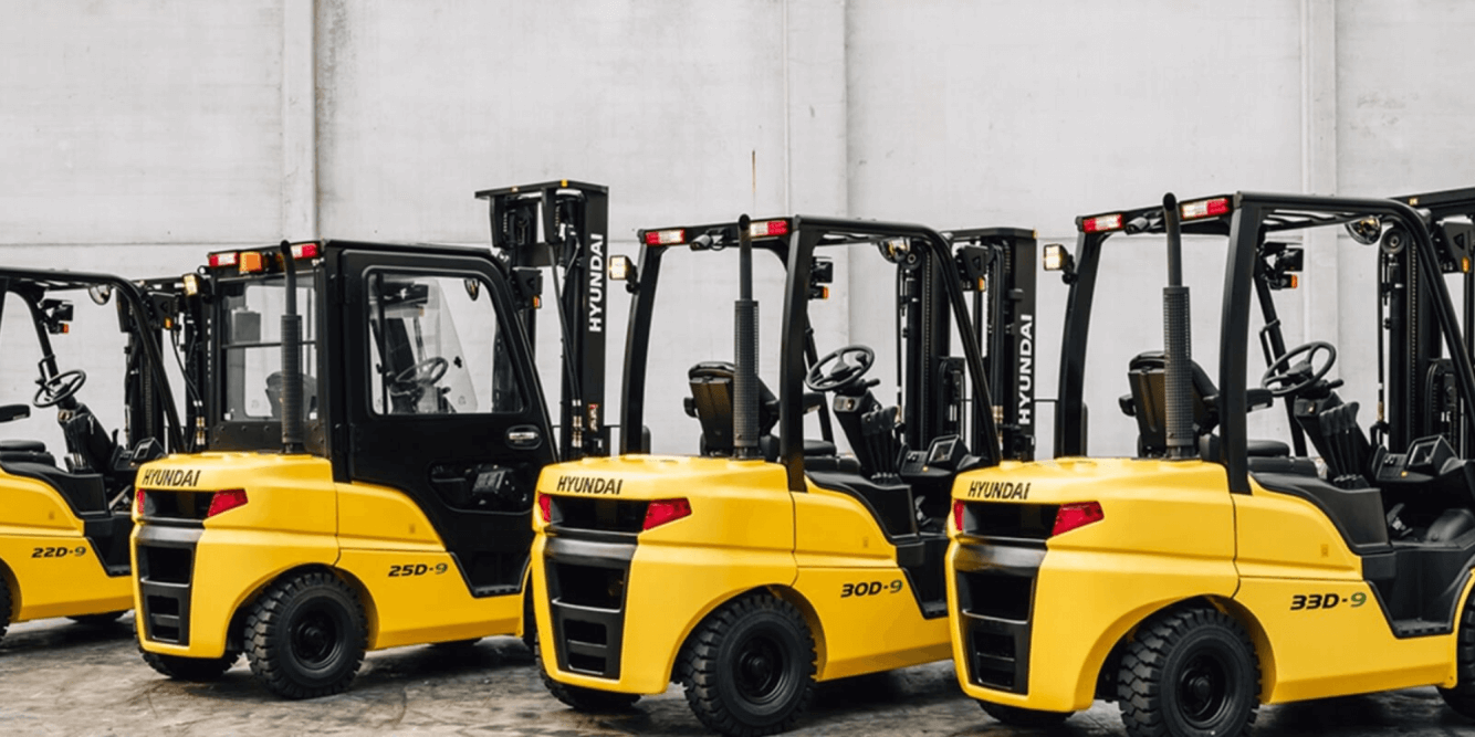 A lineup of Hyundai forklifts in a warehouse setting, showcasing various models available for businesses in Knoxville, TN with Thompson Lift Truck